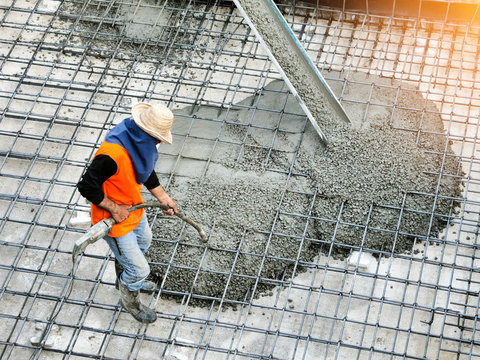 man pouring concrete