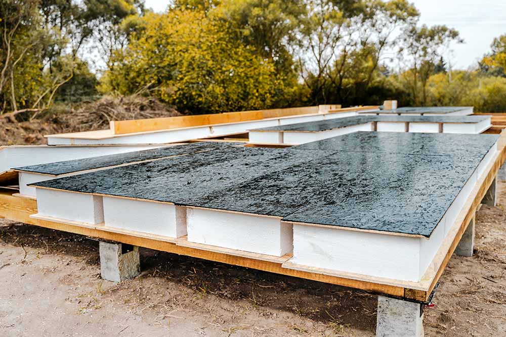 A smooth, freshly cured concrete slab with clean edges, ready for structural framing.